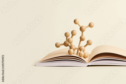 Open book with molecule models rising knowledge and science concept