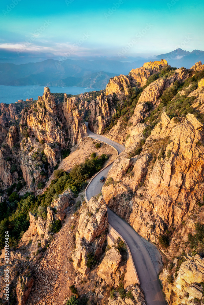 Naklejka premium Winding mountain road through Calanques de Piana in France 2024