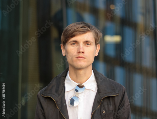 Canvastavla Portrait of serious young handsome caucasian man in casual black jacket and whit