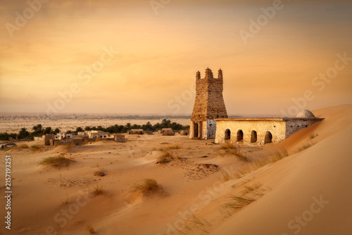 Bild auf Leinwand Ancient stone architecture half buried in desert sand in Mauritania 2025
