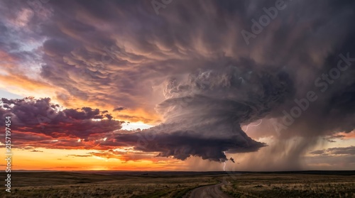 Supercell thunderstorm classic structure over empty Montana plain at sunset, High-Resolution Travel and Nature Stock Photo.