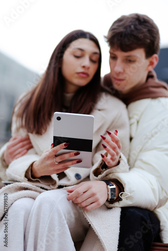 Photography Couple Using a Digital Tablet Together Outdoors Exhibiting Bonding and Interacti