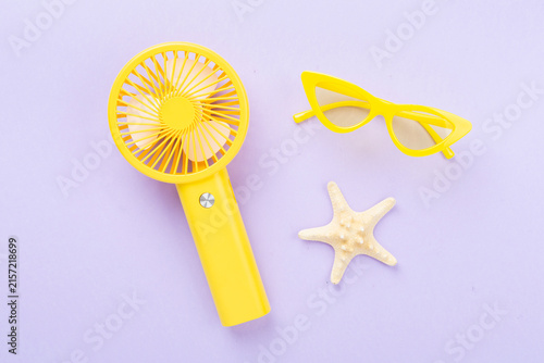 Mini electric fan on color background, top view