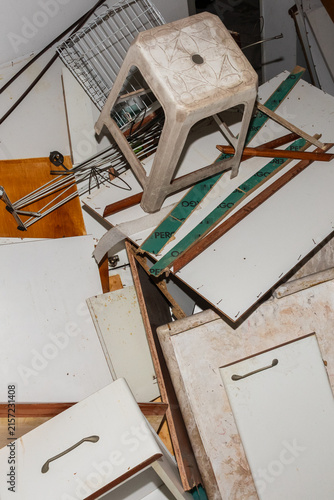 Pile of disassembled old furniture and wooden scrap for disposal. Direct lighting and sharp focus for stock photography.
