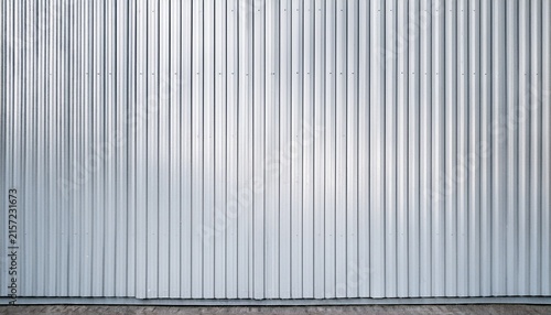 white corrugated metal wall background texture with vertical lines and rivets clean industrial surface for construction or architectural backdrop frontal view with bright natural light