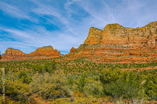 Canvastavla Layered red rock buttes rise above green high-desert scrubland in this expansive Sedona, Arizona landscape