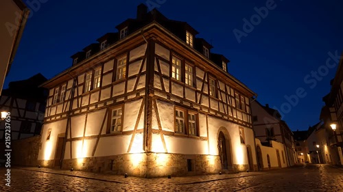 Traditional half timbered house on cobblestone street at night