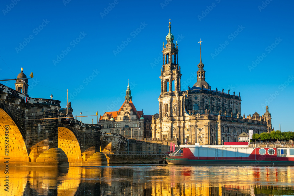 Fototapeta premium Augustus Bridge and Cathedral of the Holy Trinity with reflections in the river Elbe. Dresden, Saxony, Germany