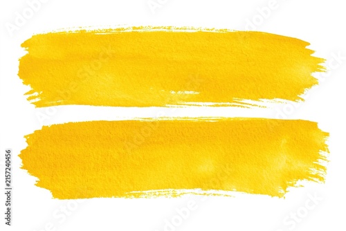 Two bright yellow watercolor brush strokes isolated on white background with rough artistic paint texture edges design.