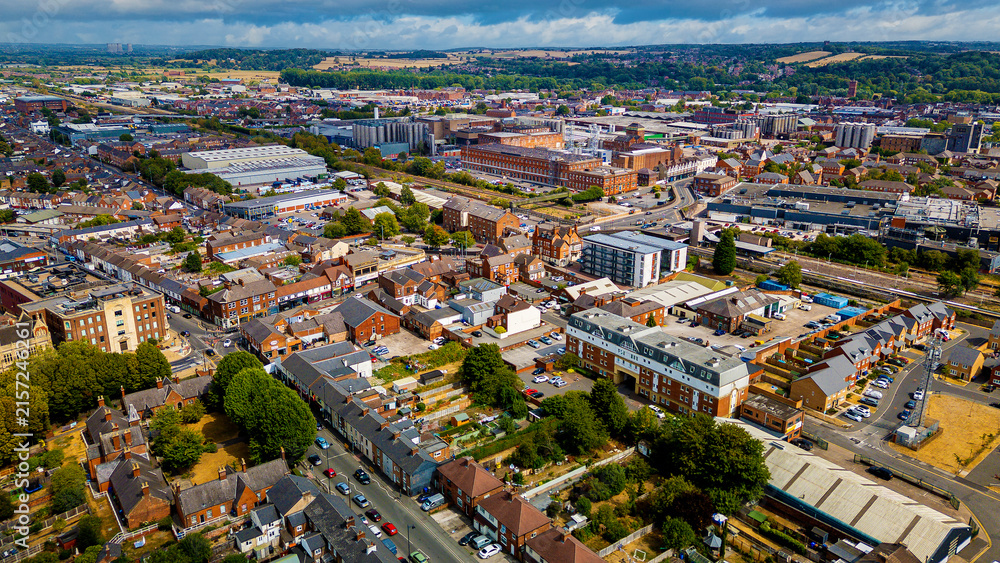 Fototapeta premium Wide drone perspective of Burton townscape with industrial breweries and railway line