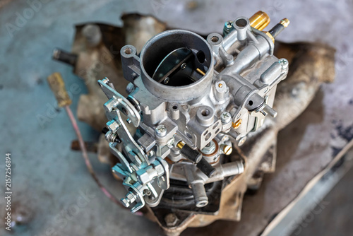 View of the carburetor throttle valve. A carburetor (also spelled carburettor or carburetter) is a device used by a gasoline internal combustion engine to control and mix air and fuel entering.