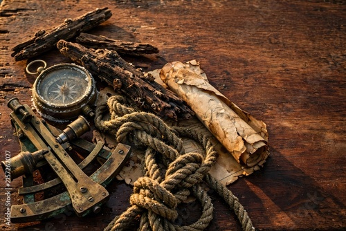 Vintage Compass, Keys, and Scroll on Rustic Wood Surface
