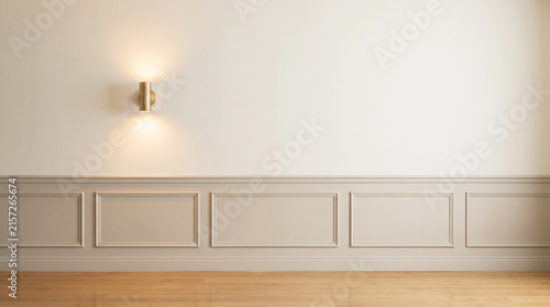Empty room interior with beige wainscoting wall paneling and brass wall lamp mockup