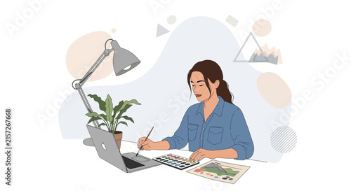 Creative designer working at desk with laptop, paint palette, and desk lamp, illustrating a modern workspace and artistic process.