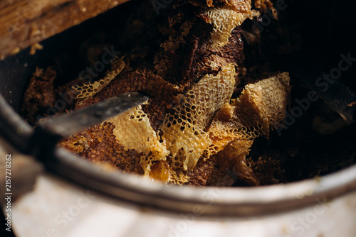 Honeycomb pieces in extractor during honey extraction process