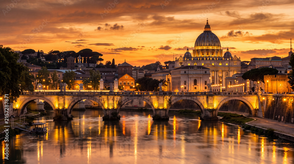 Obraz premium Historic stone bridge and grand cathedral dome at sunset over river