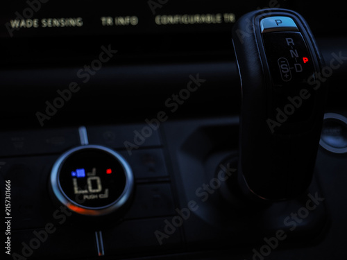 Gear shift and climate control console in off-road SUV at night