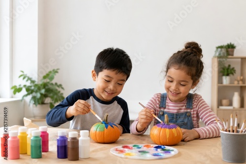 Kids painting small pumpkins craft activity