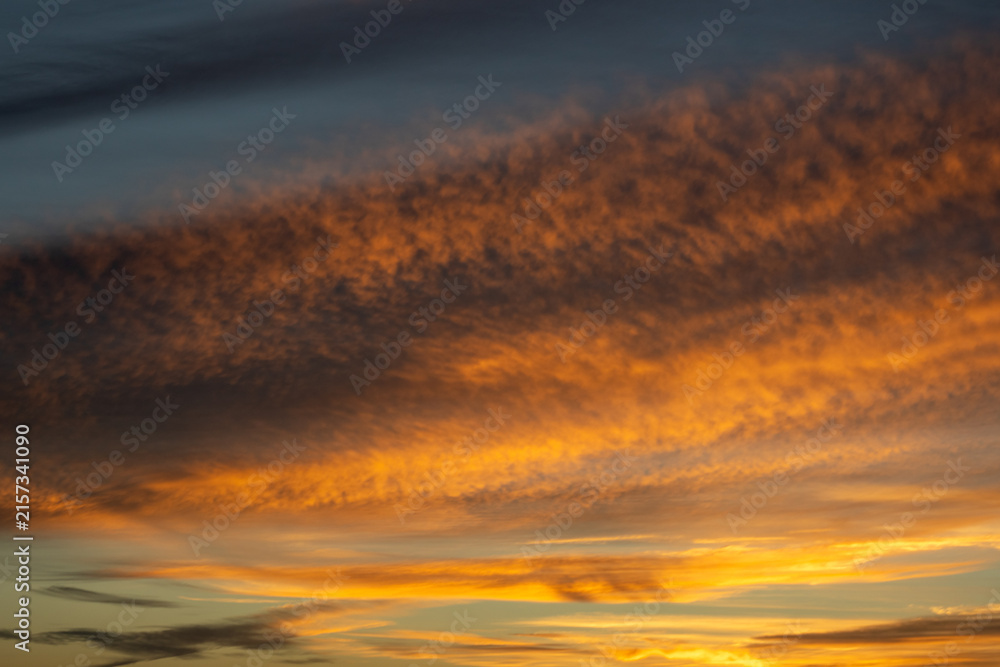 Fototapeta premium Dramatic Golden Hour Sky With Textured Clouds