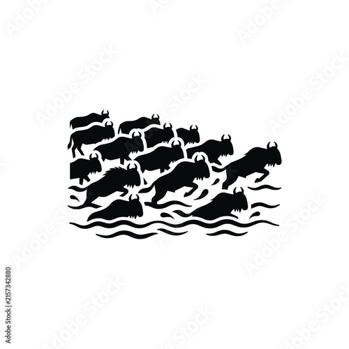 Wildebeest herd crossing river in silhouette artistic style.