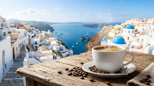 Coffee cup on balcony overlooking Oia Santorini sea view.