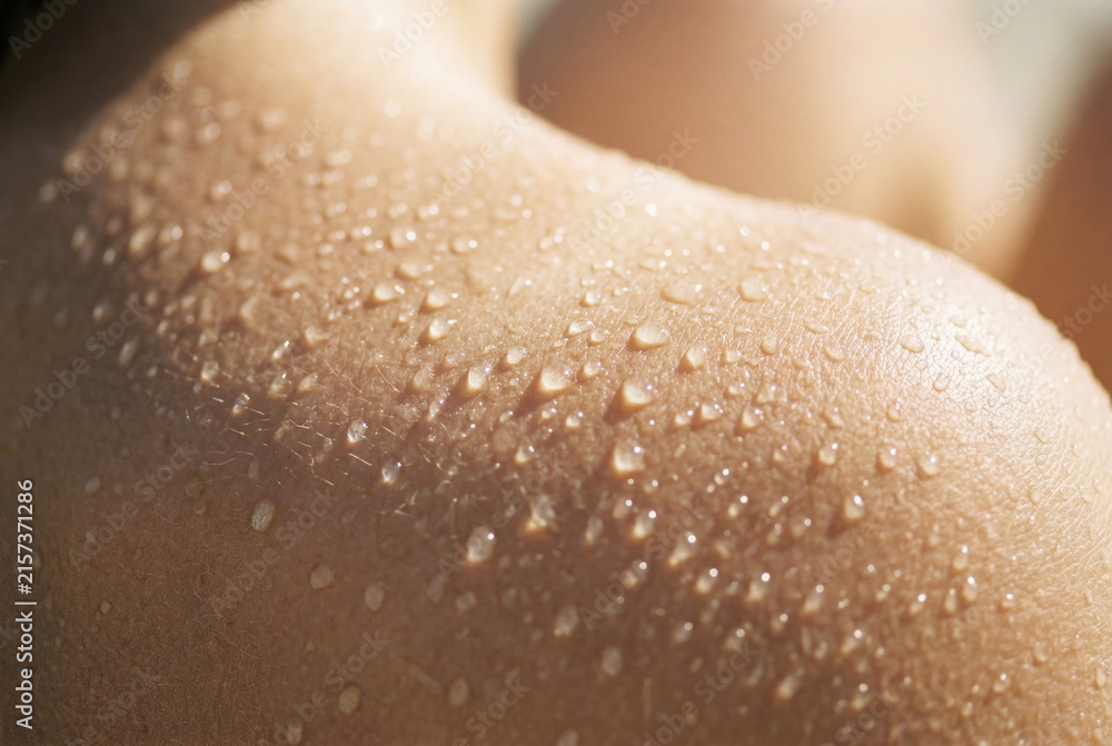 Fototapeta premium Wet human skin covered in countless glistening water droplets