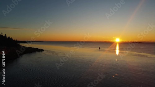 Golden sunrise light glows over the iconic Bass Harbor Head Light Station in Maine