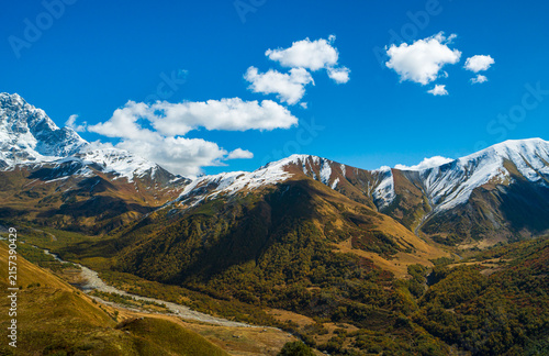 Cuadro en lienzo Landscape photograph of snow covered mountains and glacier river valley viewed from Chkhutnieri pass in Svaneti Georgia