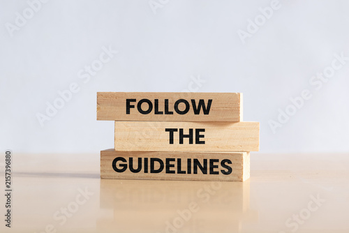 Fotografie Wooden blocks with words Follow the Guidelines. Business concept