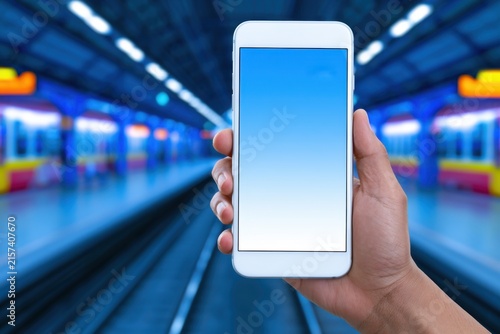 Daily smartphone usage people engaging with mobile devices at a subway station in an urban environment