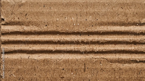 Brown corrugated cardboard texture. Detailed macro view of recycled paper packaging material.