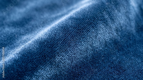 Blue velvet fabric texture. Soft luxury textile background with deep folds and fibers.