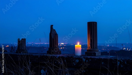 A lone candle glows brightly against the twilight sky, illuminating ancient, broken pillars, evoking a sense of history and mystery under the darkening heavens