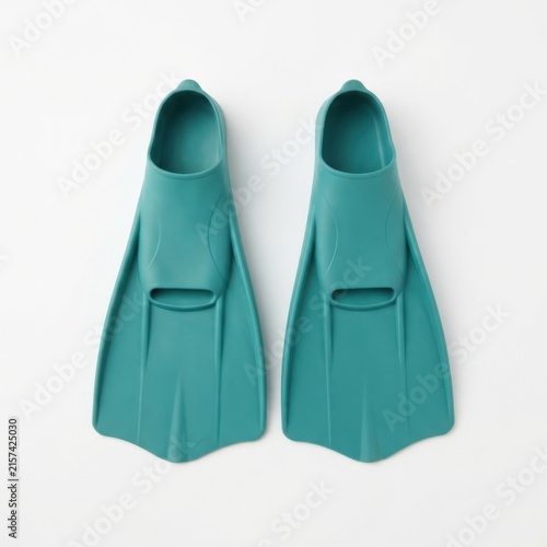 Pair of swim fins placed side by side on white background