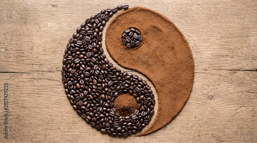 Yin yang symbol formed by coffee beans and grounds.