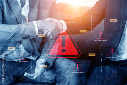 Obraz na płótnie Businessmen Shaking Hands with Warning Symbols Representing Cybersecurity Risks and Data Breaches in Modern Corporate Environment