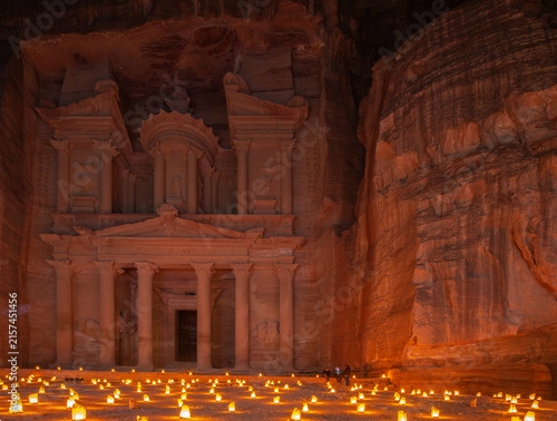 фотографія The ancient rock-cut facade of Al-Khazneh, the Treasury at Petra, illuminated by