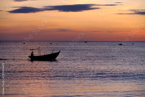 Canvastavla Photograph of a boat passing by on the sea in Da Nang, Vietnam at dawn
