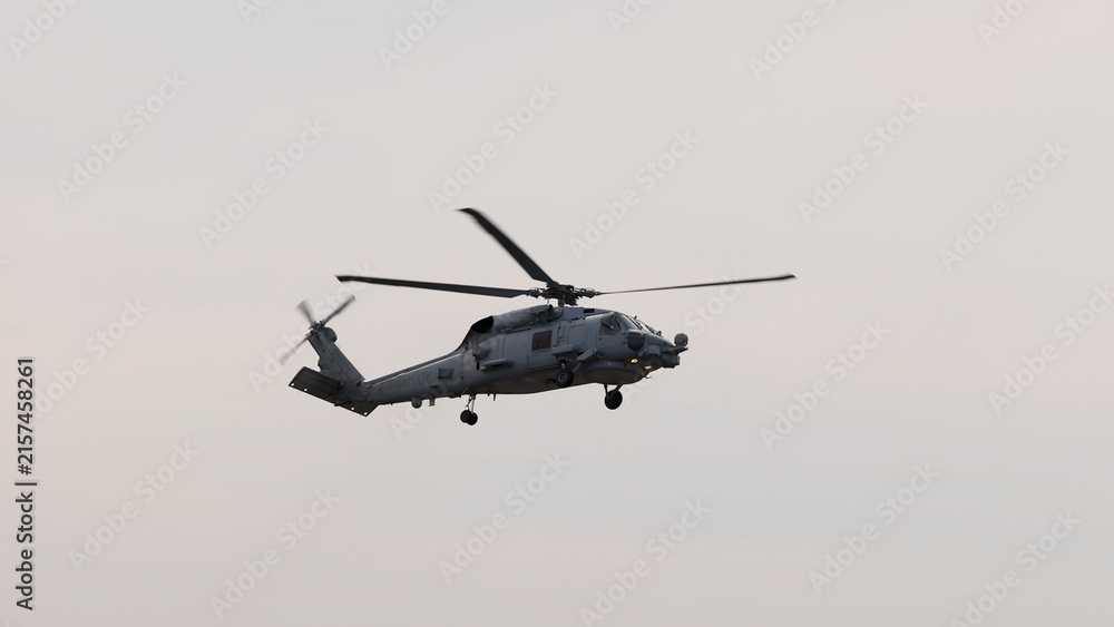 Fototapeta premium Military Black Hawk Helicopter Flying Against a Clear Sky