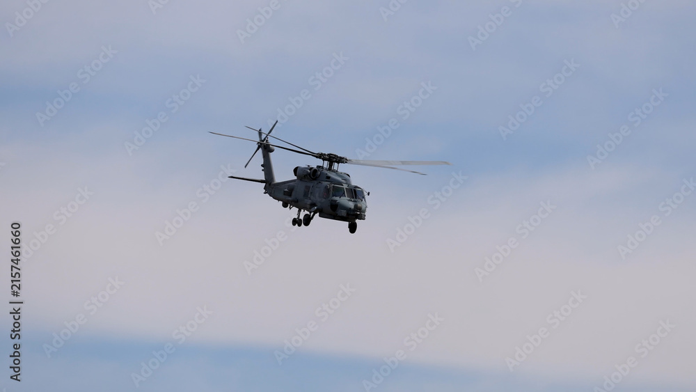 Fototapeta premium Military Sikorsky MH-60R Seahawk Helicopter Flying Against a Cloudy Sky