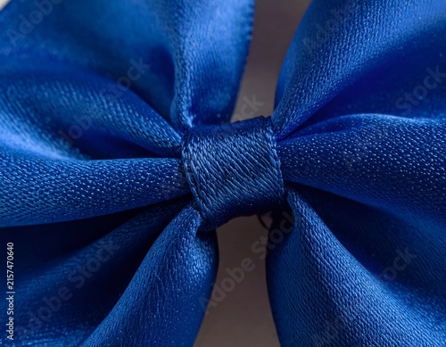 Detailed texture of blue satin ribbon bow