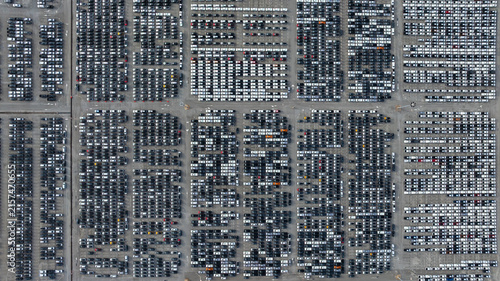 Aerial view new car lined up, Automobile automotive car parking lot commercial business industry,  Port of import export business logistic dealership, New cars global business logistic import export.