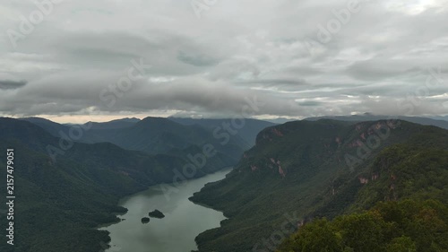 An aerial video showing the forest, mountains, and river in the morning.
