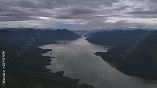 An aerial video showing the forest, mountains, and river in the morning.
