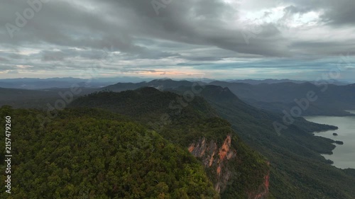 An aerial video showing the forest, mountains, and river in the morning.