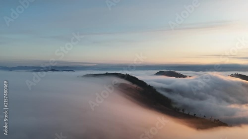 An aerial video showing misty mountains in the morning as the sun rises.