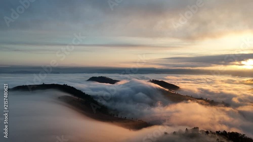 An aerial video showing misty mountains in the morning as the sun rises.