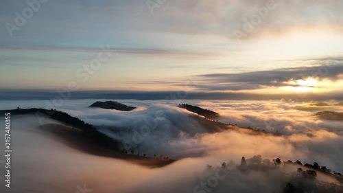 An aerial video showing misty mountains in the morning as the sun rises.