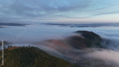 An aerial video showing misty mountains in the morning as the sun rises.