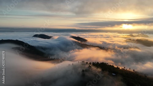 An aerial video showing misty mountains in the morning as the sun rises.